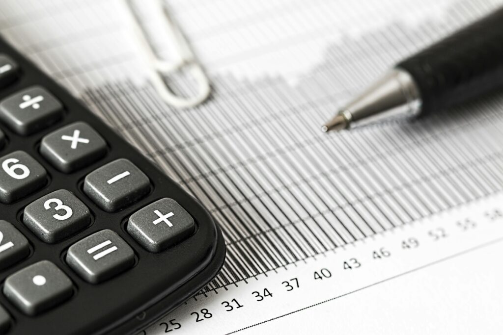 pexels-photo-209224-209224 Close-up of a calculator and pen on a bar graph, representing finance and accounting.